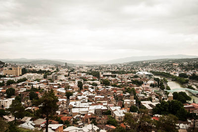 High angle view of houses in town against sky