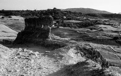 Rock formations on landscape against sky