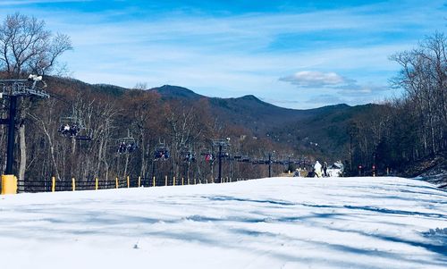 Scenic view of snow covered field against mountain