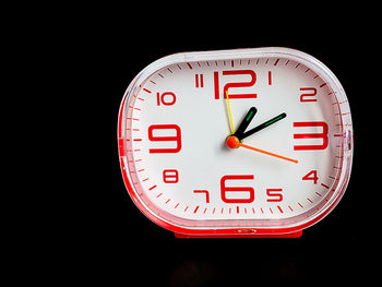 Close-up of clock against black background