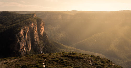 Scenic view of landscape against sky at sunset