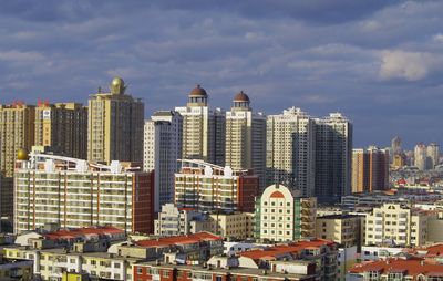 View of city against cloudy sky