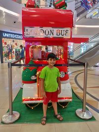 Portrait of smiling girl standing by store