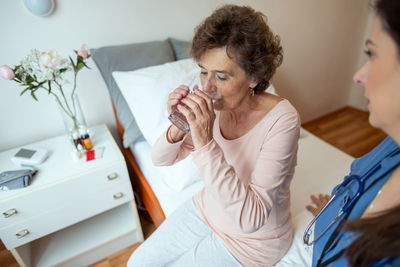 Women sitting on table at home