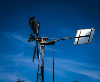 Low angle view of crane against blue sky