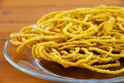 Close-up of deep fried noodles served in plate on table