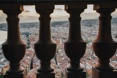 Cityscape seen through balusters during sunset