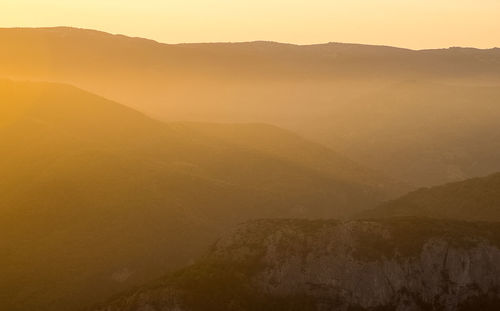 Scenic view of mountains against sky during sunset