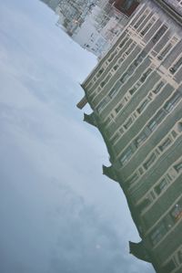 Buildings against cloudy sky