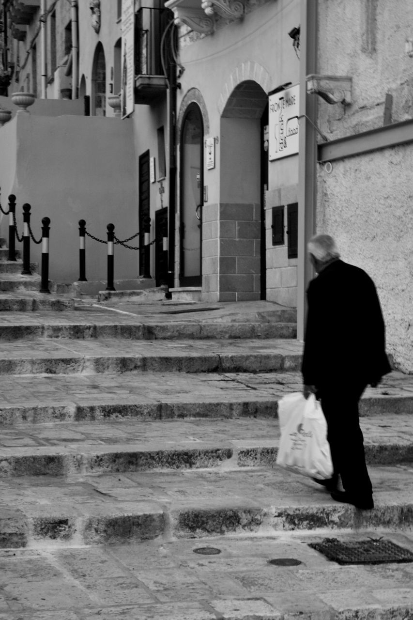 real people, architecture, one person, built structure, rear view, women, walking, lifestyles, building exterior, religion, full length, men, place of worship, outdoors, day, standing, well-dressed, adult, people