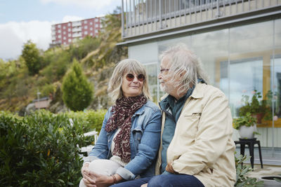 Smiling senior couple sitting outdoors