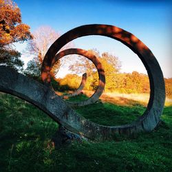 Rusty wheel on grassy field