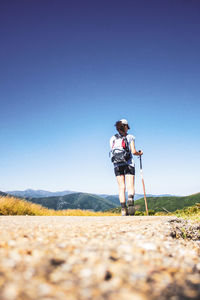 Woman standing on field against clear sky