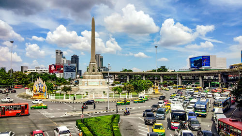 Traffic on road in city against sky