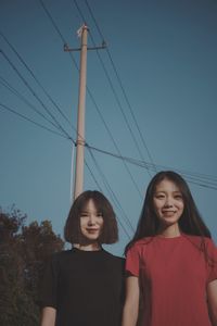 Portrait of a smiling girl against clear sky