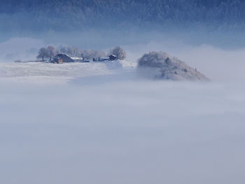 Scenic view of snow covered landscape against sky