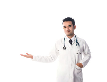 Portrait of doctor gesturing over white background