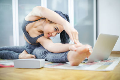 Young woman using mobile phone at home
