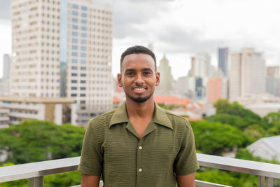 Portrait of young man standing outdoors