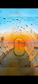 Digital composite image of people on sea shore against sky