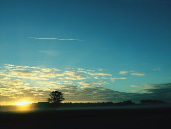 Scenic view of sunset over field