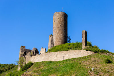 Low angle view of historic building against blue sky