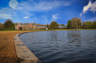 Scenic view of lake by building against sky