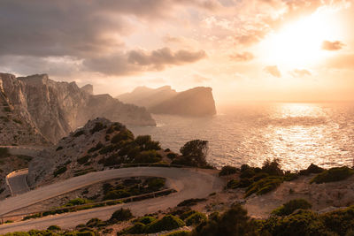 Winding road and cliffs in mallorca with reddish tones of sunset