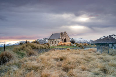 Sunrise view of the church of good shepherd with beautiful snow capped mountain range. 