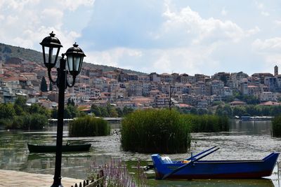 Houses in town against cloudy sky