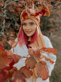 A woman with pink hair in the yellow autumn nature