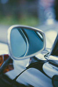 Close-up of sunglasses on side-view mirror