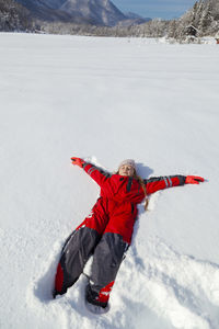 Young girl is having winter fun on a snowy, sunny day in lika, croatia