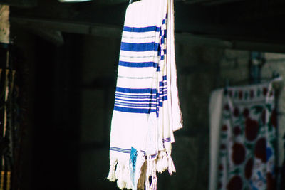 Low angle view of flags hanging against built structure