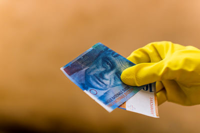 Cropped hand holding paper currency