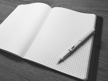 High angle view of pen and book on table