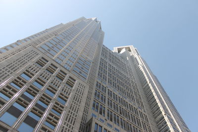 Low angle view of modern buildings against clear sky tokyo