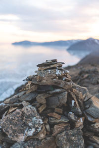 Stack of rocks on shore against sky