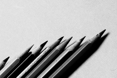 High angle view of pencils on table against white background