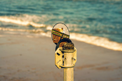 Close-up of metallic structure on beach