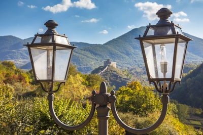 Street light and mountains against sky