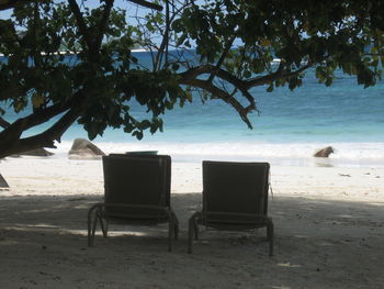 Empty chairs on beach