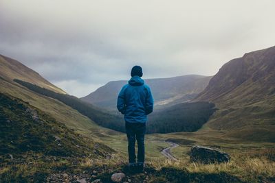 Rear view of man standing on mountain