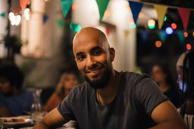 Portrait of smiling young man at restaurant