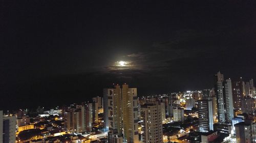 High angle view of city lit up at night