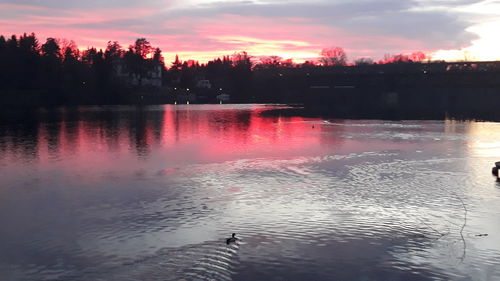 Scenic view of lake against sky during sunset