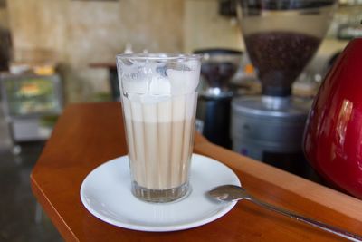 Close-up of latte macchiato in glass on table