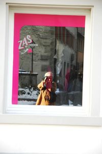 Portrait of woman photographing through window