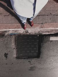 Low section of man standing on footpath