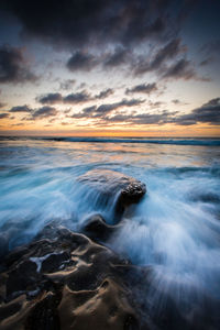 Scenic view of sea against sky at sunset